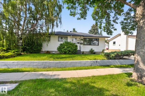 Single-story residence featuring white siding and dark trim windows - 6012 145 Avenue Nw, Edmonton, AB - Outdoor