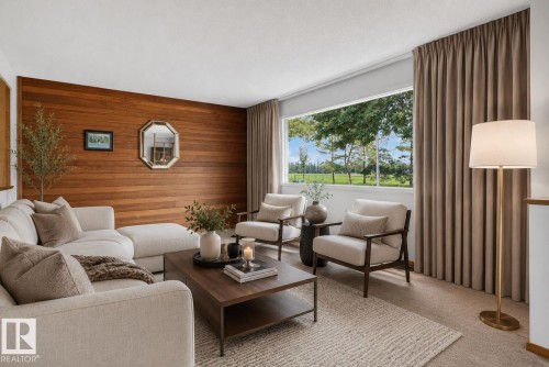 Wood-paneled accent wall with a large picture window overlooking exterior greenery - 6012 145 Avenue Nw, Edmonton, AB - Indoor Photo Showing Living Room