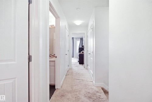 Hallway featuring light-colored carpet, white walls, and recessed lighting - #22 723 172 Street Sw, Edmonton, AB - Indoor Photo Showing Other Room