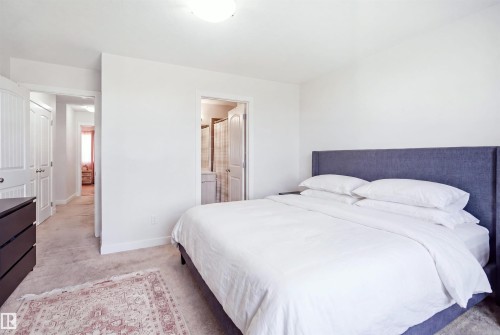 Bedroom with light-colored carpeting, white walls, and a flush-mount ceiling light - #22 723 172 Street Sw, Edmonton, AB - Indoor Photo Showing Bedroom