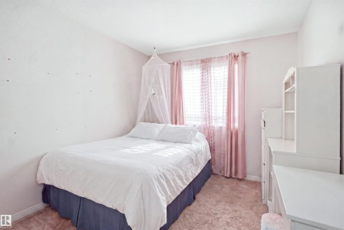 Carpeted room featuring a window with natural light, light-toned walls, and white baseboards - #22 723 172 Street Sw, Edmonton, AB - Indoor Photo Showing Bedroom