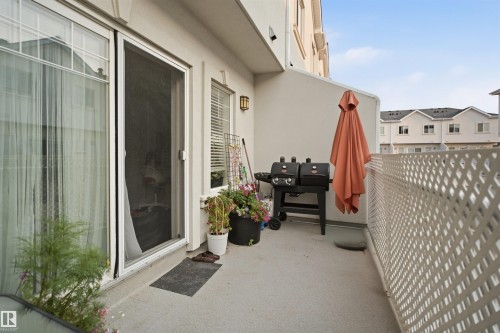 Private balcony featuring a concrete surface and white lattice railing - #22 723 172 Street Sw, Edmonton, AB - Outdoor With Exterior