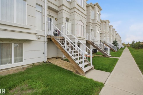 Row of townhouses featuring light-colored siding and white-framed windows - #22 723 172 Street Sw, Edmonton, AB - Outdoor