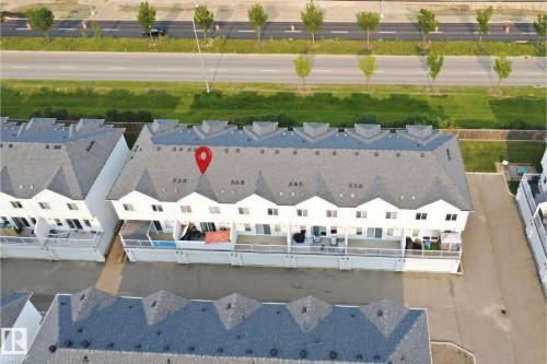 Townhome property featuring white siding and dark shingle roofing - #22 723 172 Street Sw, Edmonton, AB -  With View