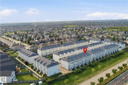 Townhouse community featuring multiple rows of units with uniformly pitched roofs and light-colored exteriors - #22 723 172 Street Sw, Edmonton, AB - Outdoor With View