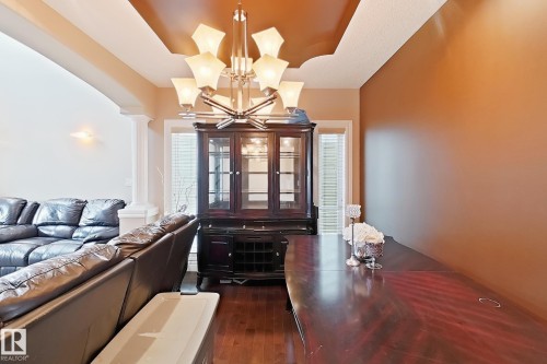 Dining area with wood-finish flooring and a tray ceiling - 5931 12 Avenue Sw, Edmonton, AB - Indoor