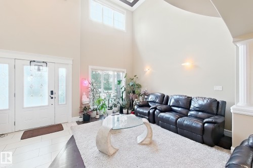 Grand entry featuring a double door with decorative glass inserts and transom windows - 5931 12 Avenue Sw, Edmonton, AB - Indoor Photo Showing Living Room
