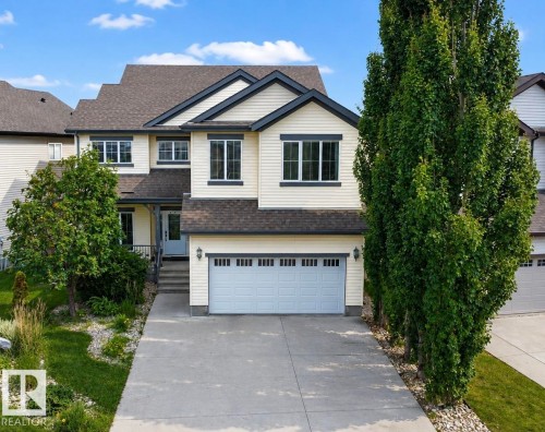 Two-story property featuring light-colored siding, contrasting dark trim, and a two-car garage - 5931 12 Avenue Sw, Edmonton, AB - Outdoor With Facade