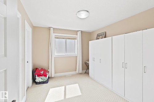 Room featuring light-toned walls, white trim, and a patterned carpet - 5931 12 Avenue Sw, Edmonton, AB - Indoor Photo Showing Other Room