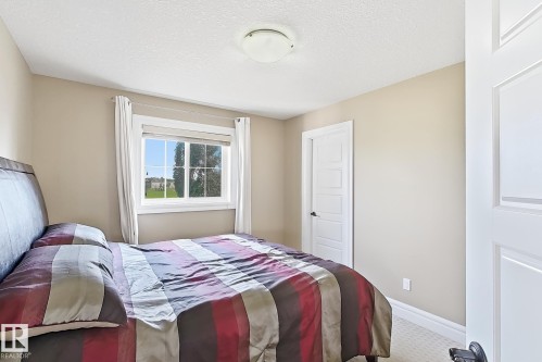 Carpeted room featuring a single window with white trim, a flush mount ceiling light, and neutral wall paint - 5931 12 Avenue Sw, Edmonton, AB - Indoor Photo Showing Bedroom
