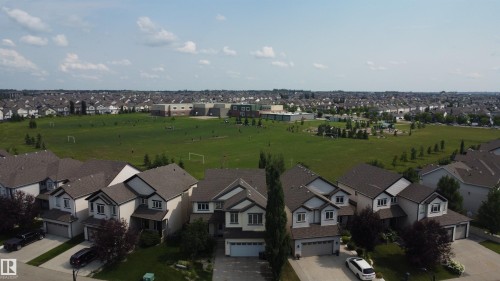 Residential neighborhood featuring contemporary homes with attached garages, gray asphalt shingle roofs, and light-toned siding - 5931 12 Avenue Sw, Edmonton, AB - Outdoor With Facade