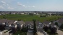 Residential neighborhood featuring contemporary homes with attached garages, gray asphalt shingle roofs, and light-toned siding - 5931 12 Avenue Sw, Edmonton, AB  - Outdoor With Facade 