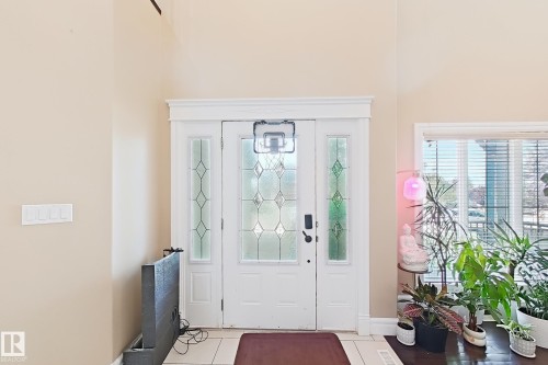 Entryway featuring a white door with decorative glass inserts, flanking sidelights with patterned glass, and a transom window above - 5931 12 Avenue Sw, Edmonton, AB - Indoor Photo Showing Other Room
