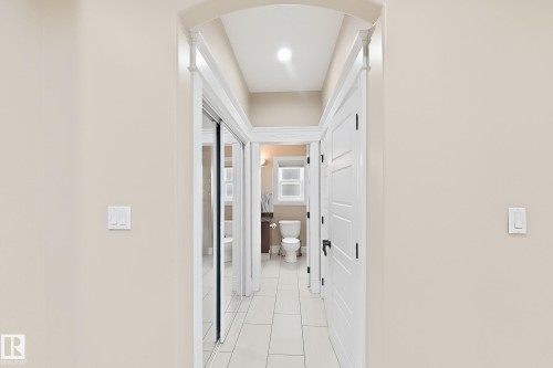 Hallway featuring light beige walls, white trim, recessed lighting, and tile flooring - 5931 12 Avenue Sw, Edmonton, AB - Indoor Photo Showing Other Room