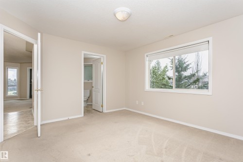 Carpeted room with neutral wall tones and white baseboards - #413 237 Youville Dr E Nw, Edmonton, AB - Indoor Photo Showing Other Room
