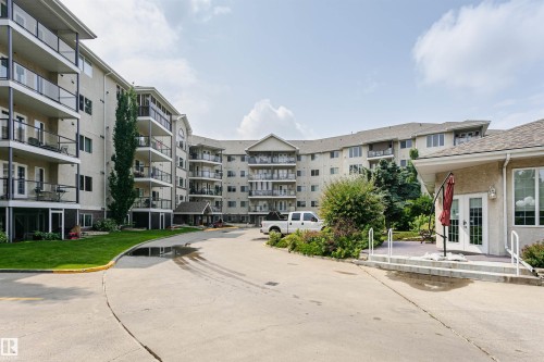 Multi-story residential building featuring private balconies with glass railings - #413 237 Youville Dr E Nw, Edmonton, AB - Outdoor With Balcony With Facade