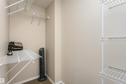 Walk-in closet featuring wire shelving - #413 237 Youville Dr E Nw, Edmonton, AB - Indoor With Storage