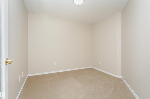 Neutral-toned carpeting throughout - #413 237 Youville Dr E Nw, Edmonton, AB - Indoor Photo Showing Other Room
