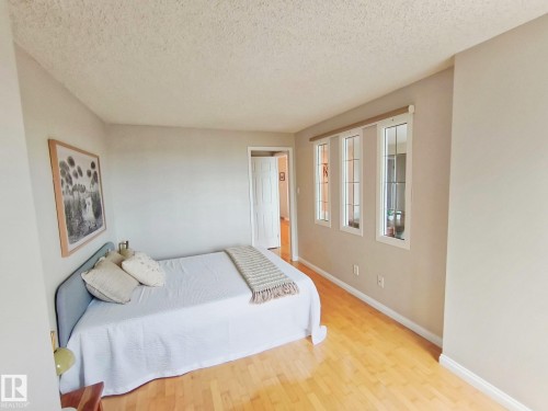 Bedroom featuring light wood-finish flooring and three-pane windows - #509 10149 Saskatchewan Dr Nw, Edmonton, AB - Indoor Photo Showing Bedroom
