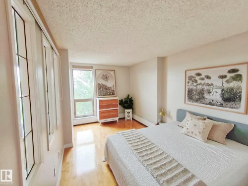 Spacious room featuring light wood-finish flooring - #509 10149 Saskatchewan Dr Nw, Edmonton, AB - Indoor Photo Showing Bedroom