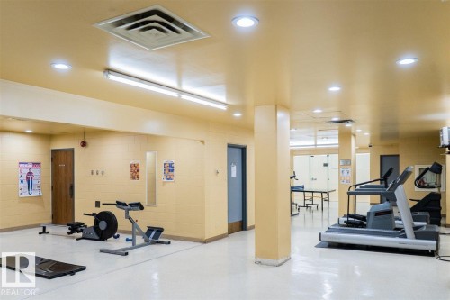 Fitness area featuring bright recessed lighting, light-colored flooring, and a variety of exercise equipment - #509 10149 Saskatchewan Dr Nw, Edmonton, AB - Indoor Photo Showing Gym Room