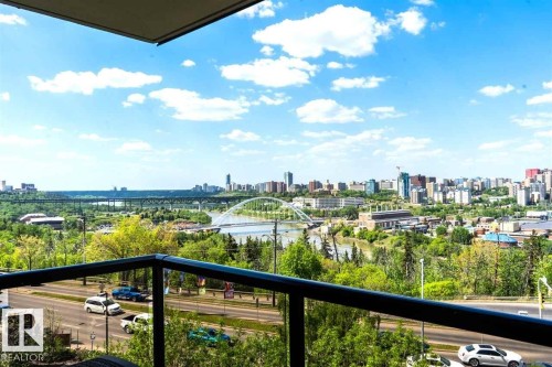 Expansive urban landscape with a river and multiple bridges, framed by a black metal and glass balcony railing - #509 10149 Saskatchewan Dr Nw, Edmonton, AB - Outdoor With View