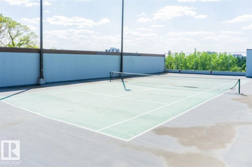 Outdoor tennis court with a hard surface, perimeter fencing, and integrated lighting fixtures - #509 10149 Saskatchewan Dr Nw, Edmonton, AB - 
