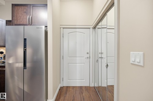 Entry area with wood-finish flooring - #443 10121 80 Av Nw, Edmonton, AB - Indoor Photo Showing Other Room