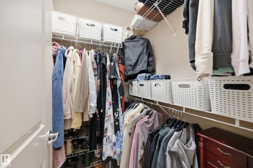 Walk-in closet featuring wire shelving, multiple hanging rods, and integrated storage solutions - #443 10121 80 Av Nw, Edmonton, AB - Indoor With Storage