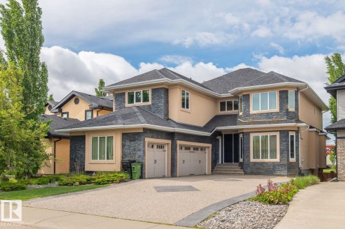 Contemporary multi-level residence featuring a neutral stucco and stone veneer exterior - 5320 Mullen Bend Nw, Edmonton, AB - Outdoor With Facade