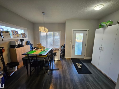 Spacious room featuring wood-finish flooring, light grey walls, and a white ceiling - 13309 104 Street Nw, Edmonton, AB - Indoor Photo Showing Dining Room