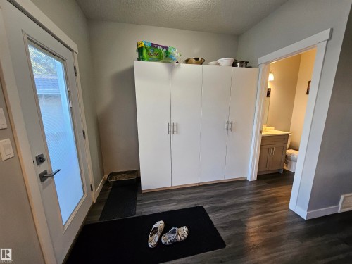 Floor-to-ceiling white cabinetry providing extensive storage - 13309 104 Street Nw, Edmonton, AB - Indoor Photo Showing Other Room