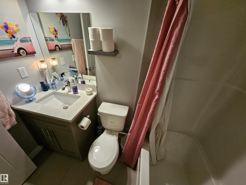 Bathroom featuring a vanity with an integrated sink, a light-toned countertop, and dark wood-finish cabinetry - 13309 104 Street Nw, Edmonton, AB - Indoor Photo Showing Bathroom