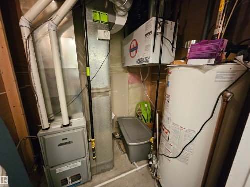 Mechanical room featuring a forced-air furnace, a water heater, and a ventilation unit - 13309 104 Street Nw, Edmonton, AB - Indoor Photo Showing Basement