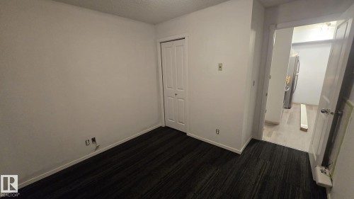 Room featuring light-colored walls and dark patterned carpet flooring - 1510 Watt Drive Southwest, Edmonton, AB - Indoor Photo Showing Other Room