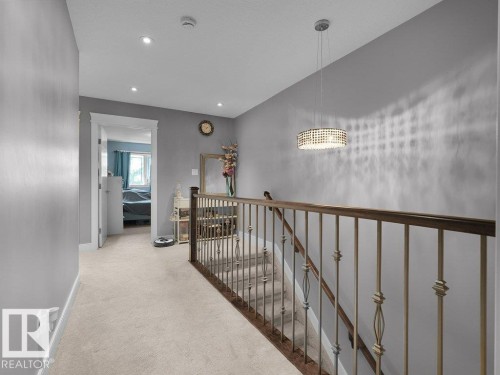 Upper-level landing featuring light gray walls and plush carpeting - 7909 105 Avenue Nw, Edmonton, AB - Indoor Photo Showing Other Room