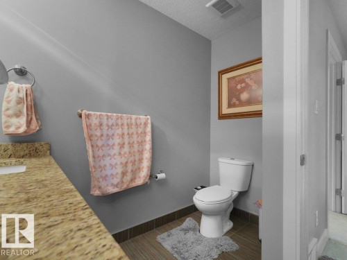 Bathroom featuring a light-toned countertop, integrated sink, and gray wall paint - 7909 105 Avenue Nw, Edmonton, AB - Indoor Photo Showing Bathroom