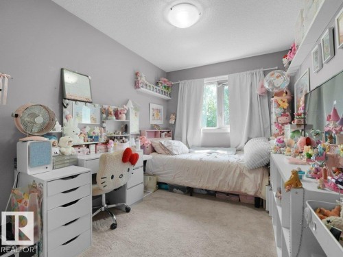 Light gray wall paint complemented by neutral-toned carpeting - 7909 105 Avenue Nw, Edmonton, AB - Indoor Photo Showing Bedroom