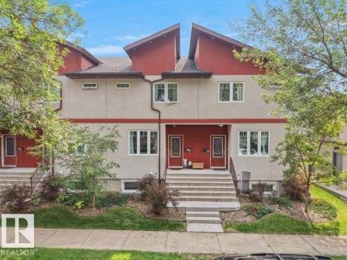 Multi-level exterior featuring stucco siding and red accent panels - 7909 105 Avenue Nw, Edmonton, AB - Outdoor