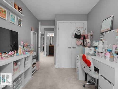 Neutral gray walls complementing light-toned carpet flooring throughout - 7909 105 Avenue Nw, Edmonton, AB - Indoor Photo Showing Bedroom