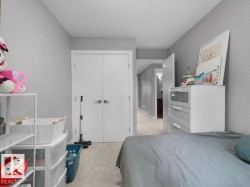 Interior room featuring neutral gray wall paint and light-colored carpet flooring - 