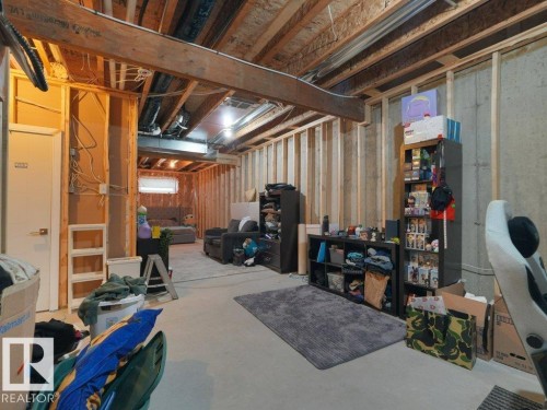 Unfinished lower level featuring exposed wood framing, concrete foundation walls, and visible ceiling joists - 7909 105 Avenue Nw, Edmonton, AB - Indoor Photo Showing Basement