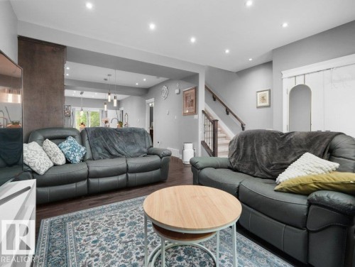Open concept living area featuring dark wood-finish flooring and recessed lighting - 7909 105 Avenue Nw, Edmonton, AB - Indoor Photo Showing Living Room