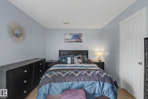 Light wood-finish flooring complements the neutral wall color - #39 3111 142 Av Nw, Edmonton, AB - Indoor Photo Showing Bedroom