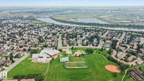 Aerial perspective showcasing a residential community with abundant green spaces - #39 3111 142 Av Nw, Edmonton, AB - Outdoor With View