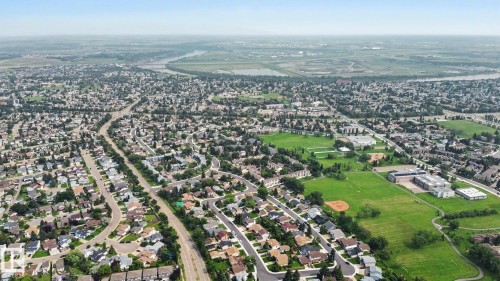 Aerial perspective showcasing a residential area with varied housing styles - #39 3111 142 Av Nw, Edmonton, AB - Outdoor With View