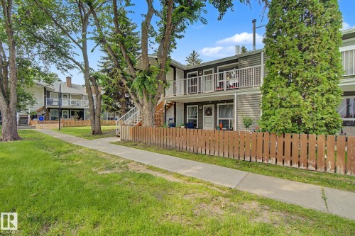 Two-story apartment building with horizontal siding and a prominent upper-level balcony featuring white railings - #39 3111 142 Av Nw, Edmonton, AB - Outdoor With Balcony