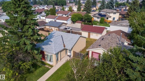Single-story residence featuring light-colored brick siding, a light gray shingled roof, and a bay window - 1719 37 Street Nw, Edmonton, AB - Outdoor