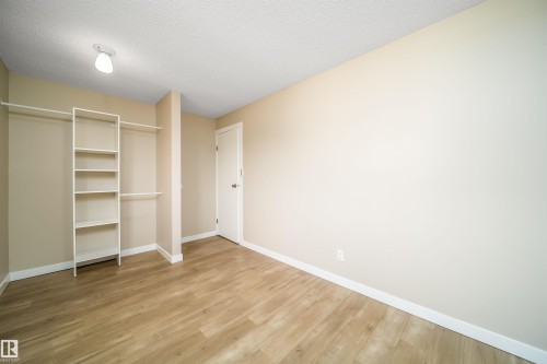 Room with wood-finish flooring, neutral wall paint, and white trim - 1719 37 Street Nw, Edmonton, AB - Indoor