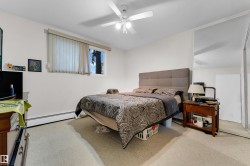 Bedroom featuring neutral carpeting and white walls - 
